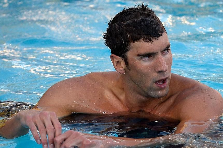 Michael Phelps - seen here on August 6 2014 after a seventh place finish in the Men's 100m Freestyle Final during the 2014 Phillips 66 National Championships in Irvine, California - is on the comeback trail after a near two-year retirement. -- PHOTO: