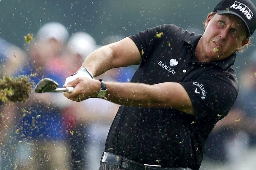 Phil Mickelson of the United States hits off a wet fourth fairway during the final round of the 2014 PGA Championship at Valhalla Golf Club in Louisville, Kentucky, August 10, 2014. -- PHOTO: REUTERS
