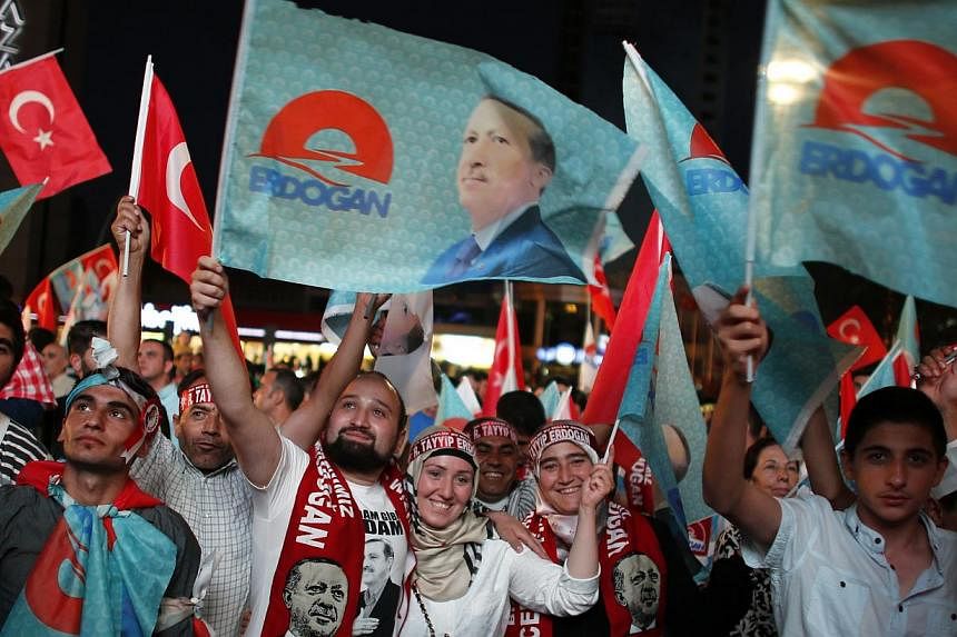 Supporters of Turkey's Prime Minister Tayyip Erdogan celebrate his victory in the presidential election in front of the party headquarters in Ankara August 10, 2014. He has&nbsp;climbed from a humble youth in Istanbul to become one of the most signif
