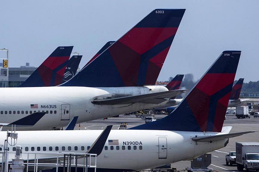 Delta Airlines planes sit at Terminal 4 at John F. Kennedy Airport July 22, 2014, in New York City.&nbsp;Beset by low air fares and relentless competition, airlines around the world are waking up to the value of their frequent flyer programmes (FFP) 