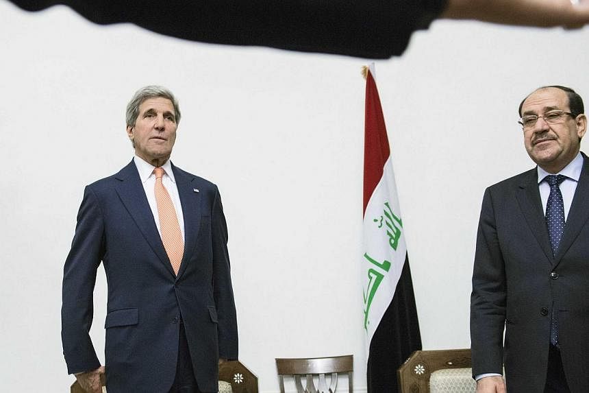 U.S. Secretary of State John Kerry (left) meets with Iraqi Prime Minister Nuri al-Maliki at the latter's office in Baghdad on June 23, 2014.&nbsp;US Secretary of State John Kerry yesterday warned Iraqi Prime Minister Nuri al-Maliki not to cause troub