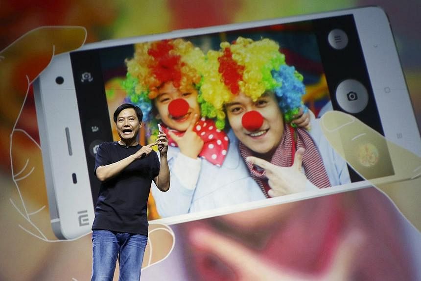 Lei Jun, founder and chief executive officer of China's mobile company Xiaomi, demonstrates the new features of the new Xiaomi Phone 4 at its launching ceremony, in Beijing on July 22, 2014.&nbsp;Xiaomi Inc said it had upgraded its operating system t