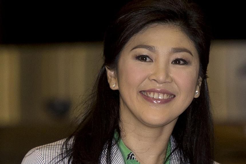 Thailand's deposed former prime minister Yingluck Shinawatra smiles as she arrives at Suvarnabhumi International airport in Bangkok on July 23, 2014.&nbsp;Former Thai Prime Minister Yingluck Shinawatra has returned home from a trip overseas, putting 
