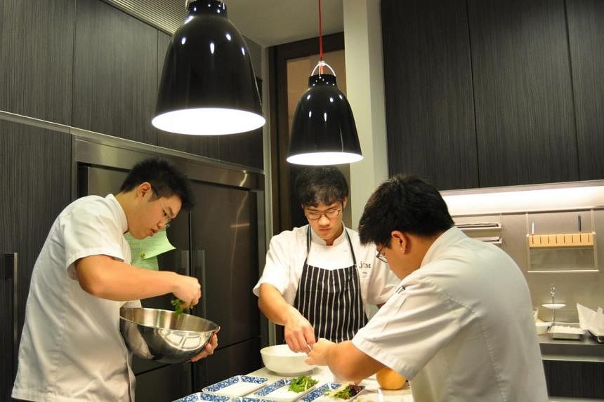 Amateur chefs (from left) Jeremy Cheok, Alroy Chan, and Ming Tan, cooking together. More and more men are taking to cooking in a sign of changing times. STPHOTO: TAN HUANG MING