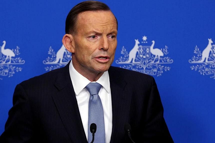 A shocking image of what is believed to be the young son of an Australian man holding a decapitated head in Syria showed how barbaric the Islamic State (IS) "terrorist army" is, Prime Minister Tony Abbott said on Monday. -- PHOTO: AFP&nbsp;
