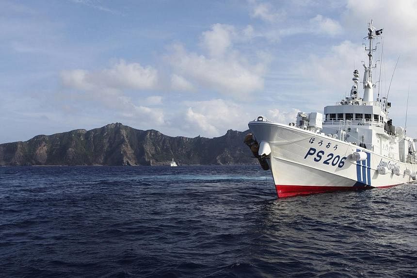 Japan Coast Guard vessel PS206 Houou sails in front of Uotsuri island, one of the disputed islands, called Senkaku in Japan and Diaoyu in China, in the East China Sea, in this Aug 18, 2013 file photo.&nbsp;Japan's ruling Liberal Democratic Party will