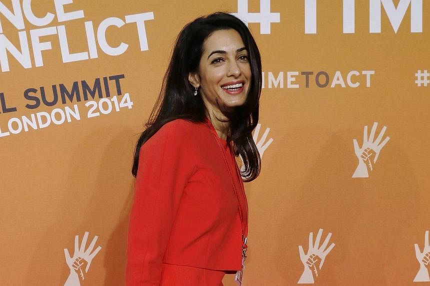 Hollywood star George Clooney's fiancee Amal Alamuddin, seen here at a London summit in June 2014, has declined her nomination to join a commission probing Israel's Gaza offensive due to "prior professional commitments". -- PHOTO: REUTERS