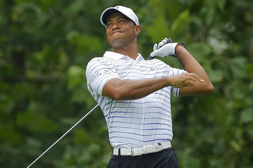 Tiger Woods of the US grimaces after hitting his tee shot on the seventh hole during the second round of the 2014 PGA Championship at Valhalla Golf Club in Louisville, Kentucky, on August 8, 2014. Woods has played a limited schedule this year followi