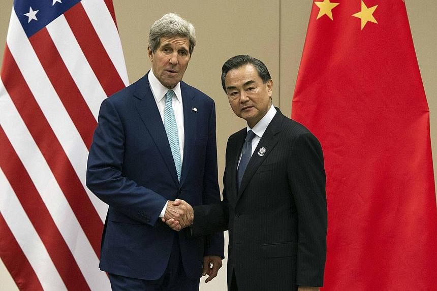 US Secretary of State John Kerry shaking hands with Chinese Foreign Minister Wang Yi at the Asean Regional Forum in Naypyitaw, Myanmar, on August 9, 2014. Mr Wang suggested the US' aim regarding disputes over the South China Sea might be "to&nbsp;cre