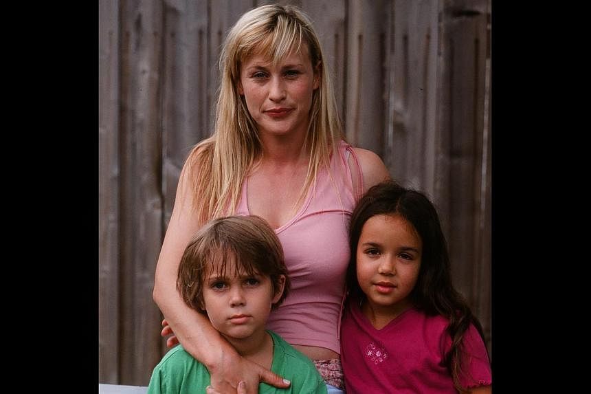 Young actor Ellar Coltrane (far right), seen on the right with his co-stars Patricia Arquette (background) and Lorelei Linklater), has been filmed growing up in the movie.