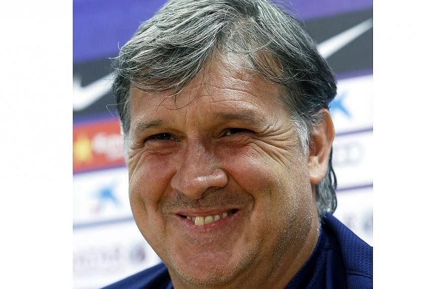 Former Barcelona's coach Gerardo Martino smiles during a news conference in Barcelona in this May 16, 2014 file photo.&nbsp;Martino was named coach of Argentina on Tuesday replacing Alejandro Sabella who stood down after they lost 1-0 to Germany in J