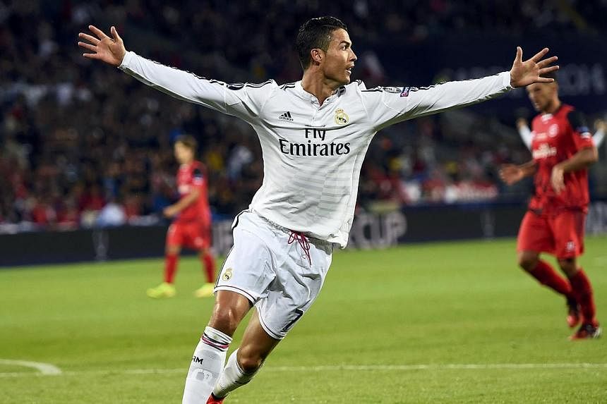 Real Madrid's Cristiano Ronaldo celebrates after scoring his second goal against Sevilla during the UEFA Super Cup final soccer match at Cardiff City stadium, Wales, August 12, 2014. -- PHOTO: REUTERS