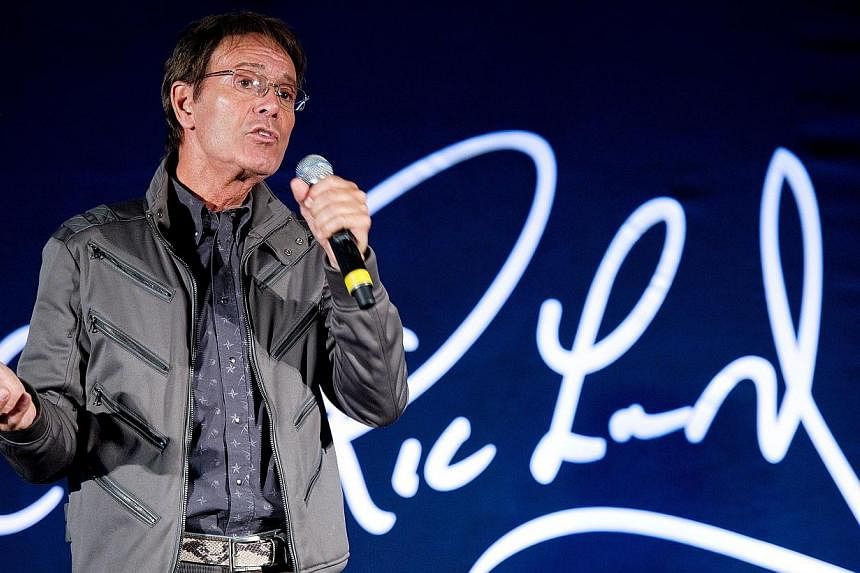 British musician Sir Cliff Richard attends a press conference in London to promote his yet-to-be recorded album of soul classics on March 7, 2011. British police searched a property belonging to Richard on Thursday, Aug 14, 2014, as part of an invest