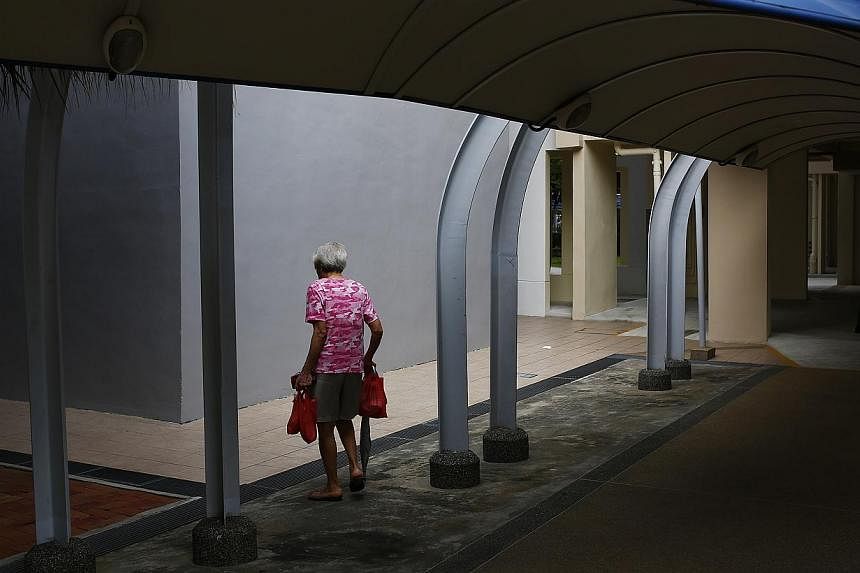 An elderly woman walks under a sheltered walkway in Marine Terrace on Feb 8, 2013.&nbsp;People are getting more tech-savvy so studio apartments for the elderly should in the future have video conferencing technology. -- PHOTO: ST FILE