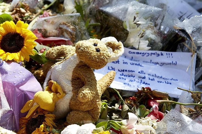Flowers and stuffed animals are left in memory of the victims of Malaysia Airlines flight MH17 at the Korporaal van Oudheusdenkazerne in Hilversum, where the identification process of the victims is taking place on Aug 3, 2014.&nbsp;Malaysia has decl