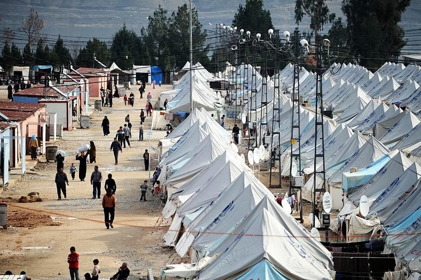 Syrian refugees walking among tents at Karkamis' refugee camp near the town of Gaziantep, south of Turkey on Jan 16, 2014.&nbsp;The Turkish authorities were moving hundreds of Syrian refugees on Thursday, Aug 14, 2014, from the southern city of Gazia