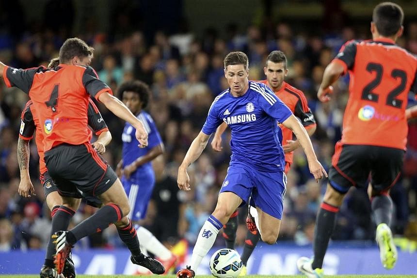 Chelsea's Fernando Torres (centre) is surrounded by Real Sociedad players during their friendly soccer match at Stamford Bridge in London on Aug 12, 2014. Torres' dramatic loss of form since his high-profile transfer from Liverpool to Chelsea in 2011