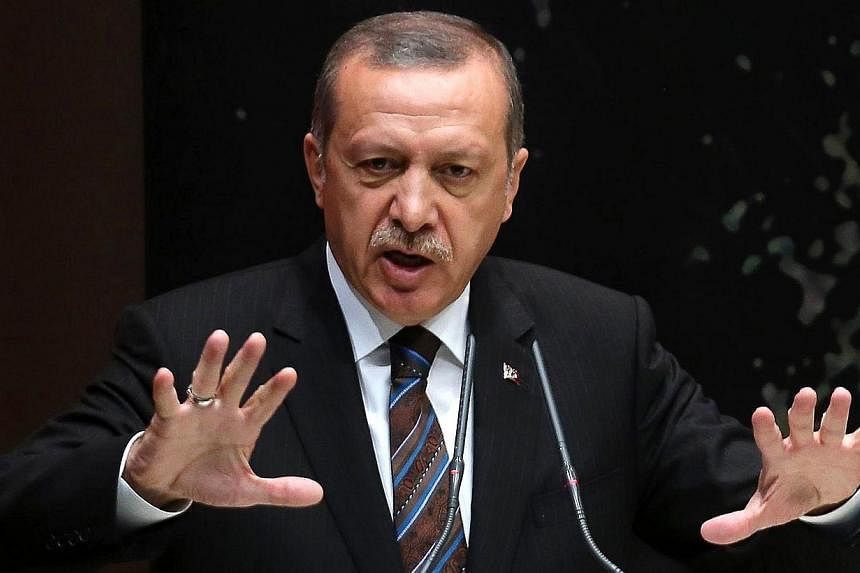 Turkey's Prime Minister Tayyip Erdogan addresses members of his ruling AK Party (AKP) during a meeting at the party headquarters in Ankara on Aug 14, 2014. Turkish Prime Minister Recep Tayyip Erdogan on Thursday, Aug 14, 2014, launched a blistering n