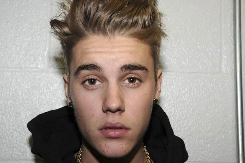 Canadian pop singer Justin Bieber is pictured in police custody in Miami Beach, Florida on January 23, 2014 in this Miami Beach Police Department handout released to Reuters on March 4, 2014. He&nbsp;pleaded guilty in absentia on Wednesday to lesser 