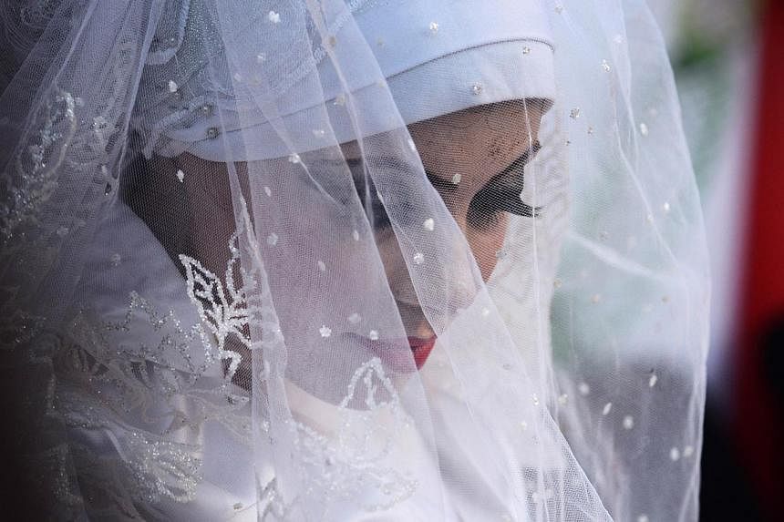 Heba wearing a veil over her white dress.&nbsp;Heba's family home was destroyed along with the items she and Omar had bought for married life: dresses, accessories, flowers, everything went up in smoke when Israeli warplanes rained destruction on Gaz