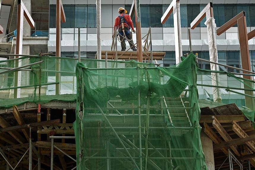 Developers who successfully bid for projects on selected government land sales sites will have to adopt more productive construction methods by the end of this year. -- PHOTO: ST FILE