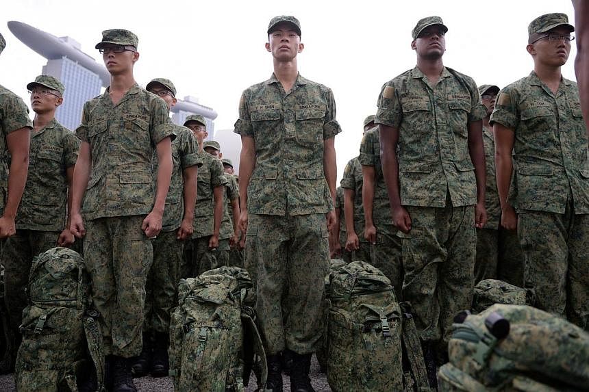 Recruits stand at attention during their Basic Military Training (BMT) during the Passing Out Parade held at the Floating Platform@Marina bay on April 12, 2014. -- ST PHOTO: MARK CHEONG