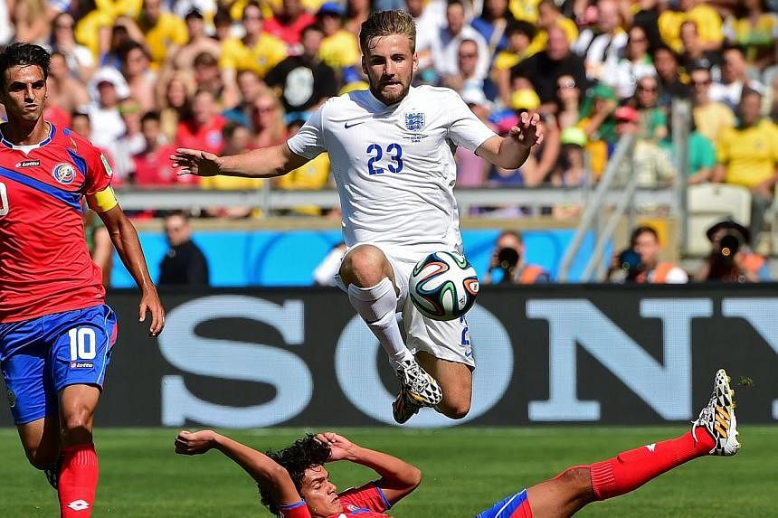 Manchester United's Luke Shaw (top), seen here in action for England during World Cup 2014, will miss the start of the Premier League season and could be sidelined for four weeks after suffering a hamstring injury, the club said on Wednesday. -- PHOT