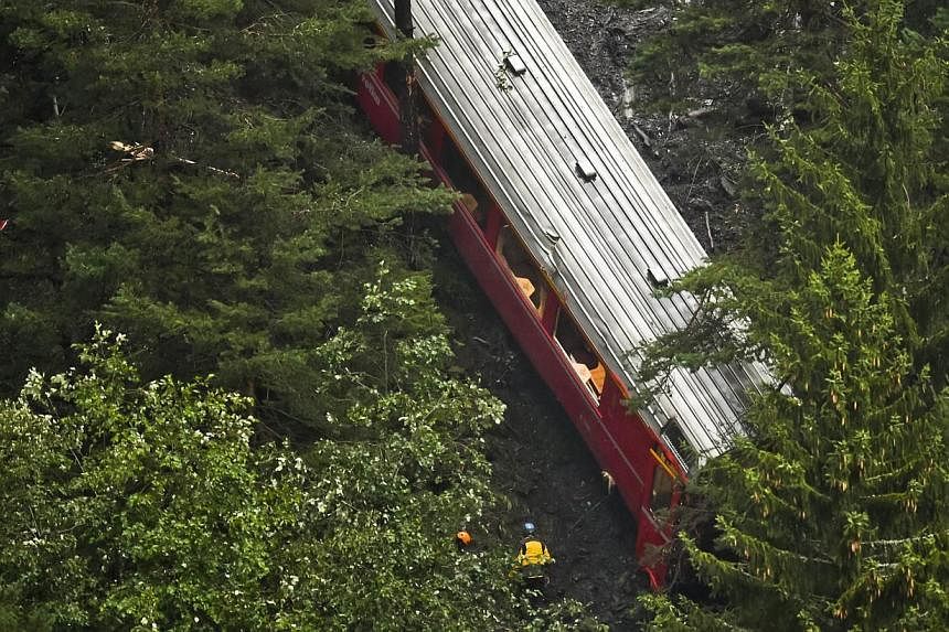 View of a train after it was derailed by a landslide near Tiefencastel, in a mountainous part of eastern Switzerland, on Aug 13, 1014. -- PHOTO: AFP