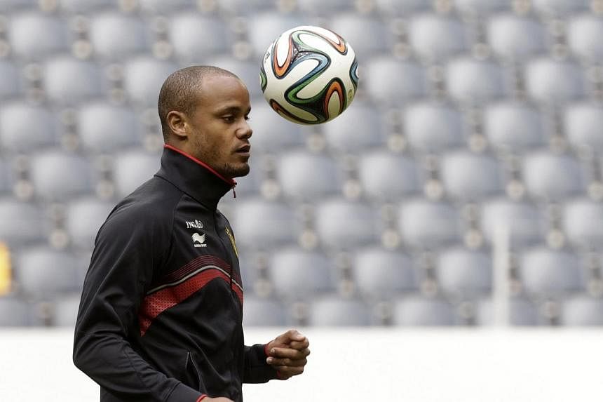 Vincent Kompany controlling a ball during a training session ahead of the 2014 World Cup, in Stockholm in May. Kompany has signed a new five-year contract with English Premier League champions Manchester City, it was announced on Wednesday. -- PHOTO: