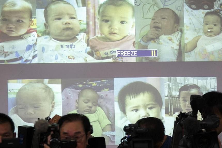 Surrogate babies that Thai police suspect were fathered by a Japanese businessman who has fled from Thailand are shown on a screen during a news conference at the headquarters of the Royal Thai Police in Bangkok on Aug 12, 2014. Authorities have foun