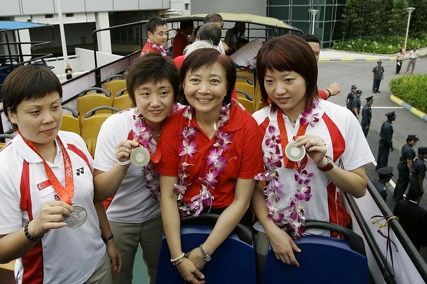 Singapore Table Tennis Association (STTA) president Lee Bee Wah (second from right) with paddlers (from left) Wang Yuegu, Feng Tianwei and team captain Li Jiawei at a victory tour after their team silver medal at the 2008 Beijing Olympics. -- PHOTO: 