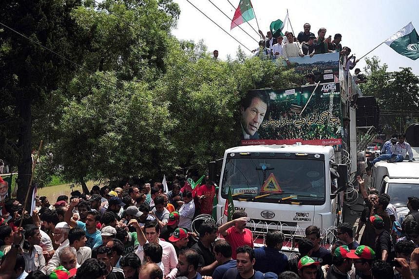 Pakistan cricketer-turned-politician Imran Khan (top, centre) heads a protest march from Lahore to Islamabad against the government, in Lahore on August 14, 2014. Thousands of protesters gathered in the Pakistani city of Lahore on August 14, preparin