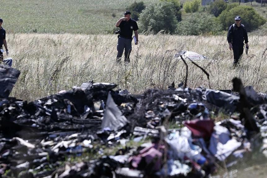 International experts investigating the site of downed Malaysia Airlines Flight MH17 in the Donetsk region, in eastern Ukraine on August 1, 2014.&nbsp;Dutch forensic experts have identified a total of 127 victims, with 20 new names being released to 