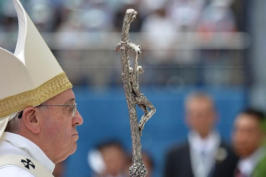 Pope Francis takes part in a mass in front of thousands of followers at Daejeon World Cup Stadium on Aug 15, 2014.&nbsp;Pope Francis met relatives of South Korea's ferry disaster on Friday as 45,000 people packed into a sports stadium for a mass on t