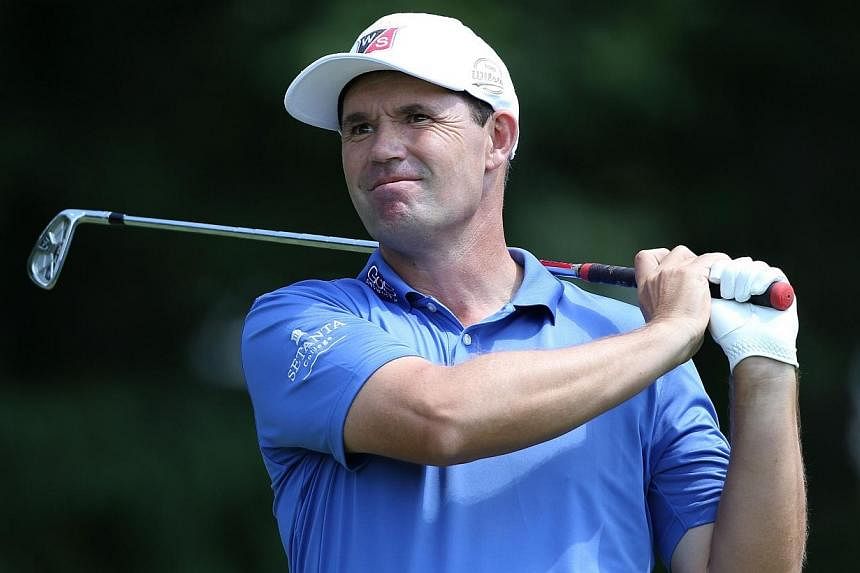 Padraig Harrington of Ireland plays his tee shot on the seventh hole during the first round of the Wyndham Championship at Sedgefield Country Club on Aug 14, 2014 in Greensboro, North Carolina.&nbsp;-- PHOTO: AFP