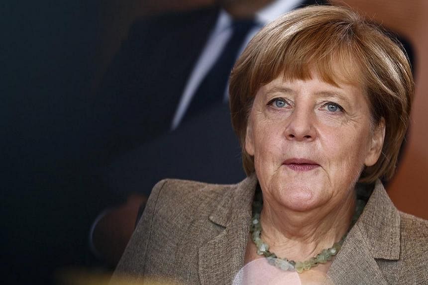 German Chancellor Angela Merkel attends a cabinet meeting at the Chancellery in Berlin on Aug 13, 2014.&nbsp;Dr Merkel urged Russian President Vladimir Putin to "stop the flow of military equipment, military advisers and armed personnel crossing the 