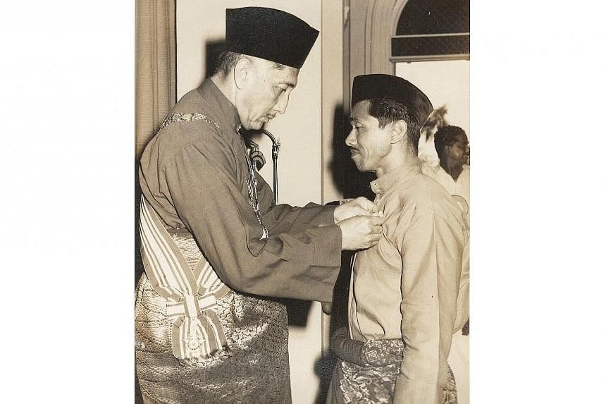 Mr Rahmat Yusak receiving his Public Service Medal (Bronze) from then President Yusof Ishak.&nbsp;-- PHOTO:&nbsp;COURTESY OF ZULKIFLI RAHMAT