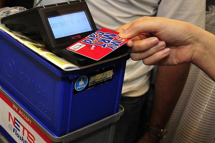 Some debit cards are also FlashPay cards that can be used for contactless payment at food courts and supermarkets and for MRT and bus rides. -- PHOTO: DIOS VINCOY JR FOR THE SUNDAY TIMES