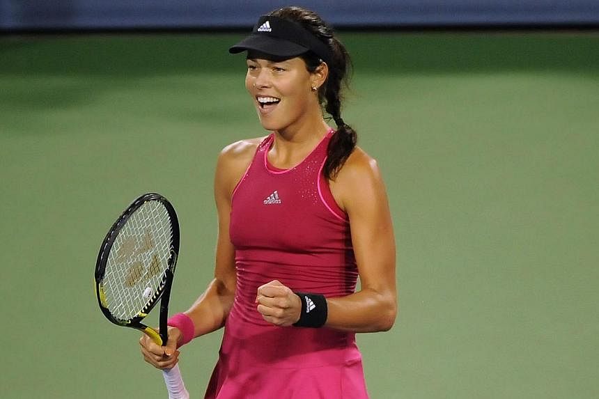 Ana Ivanovic of Serbia celebrates after defeating Maria Sharapova of Russia after a match on day 8 of the Western &amp; Southern Open at the Linder Family Tennis Center in Cincinnati, Ohio on Aug 16, 2014. -- PHOTO: AFP&nbsp;