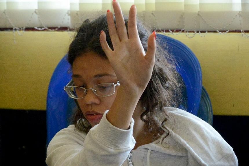 Heather Mack, suspected in the murder of her mother Sheila von Wiese Mack, gestures while in custody at a police station in Denpasar on the Indonesian resort island of Bali on Aug 14, 2014.&nbsp;An American teenager suspected of killing her mother, w