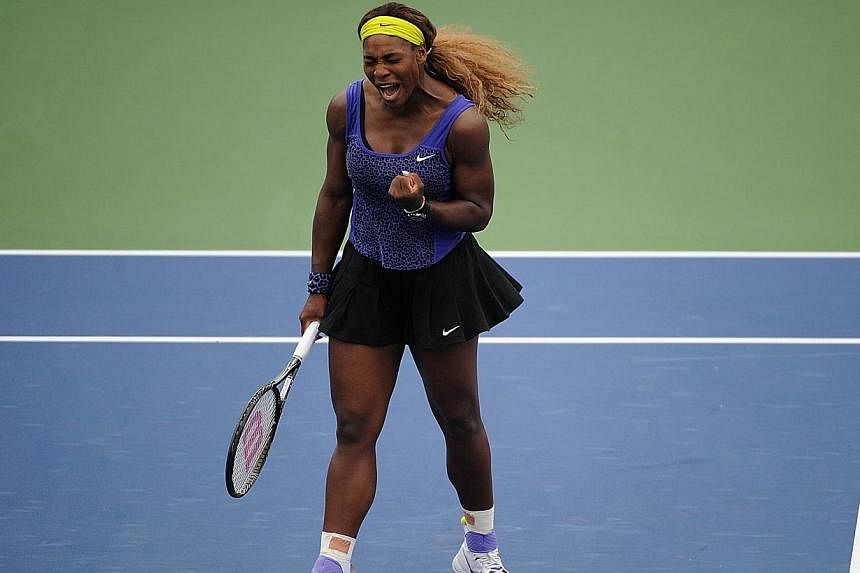 Serena Williams celebrates during a match against Caroline Wozniacki of Denmark on day 8 of the Western &amp; Southern Open at the Linder Family Tennis Center in Cincinnati, Ohio on August 16, 2014. -- PHOTO: AFP