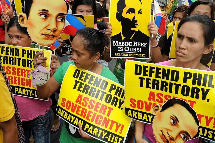 Filipino protesters display placards during a rally against China's claim to areas of the South China Sea, at the Chinese consulate in Manila on June 12, 2014.&nbsp;The Philippines on Monday protested recent Chinese "sovereignty patrols" that it said