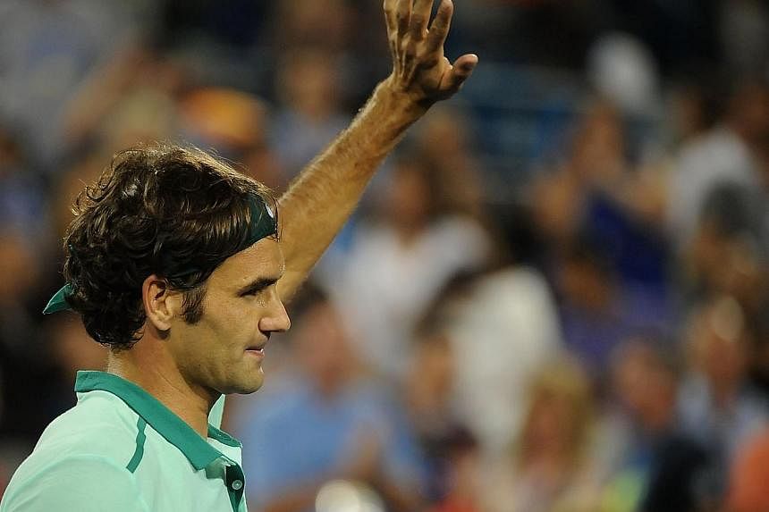 Roger Federer of Switzerland celebrates after winning against Milos Raonic of Canada on day 8 of the Western &amp; Southern Open at the Linder Family Tennis Center on Aug 16, 2014 in Cincinnati, Ohio.&nbsp;Federer won his 80th career title with a 6-3