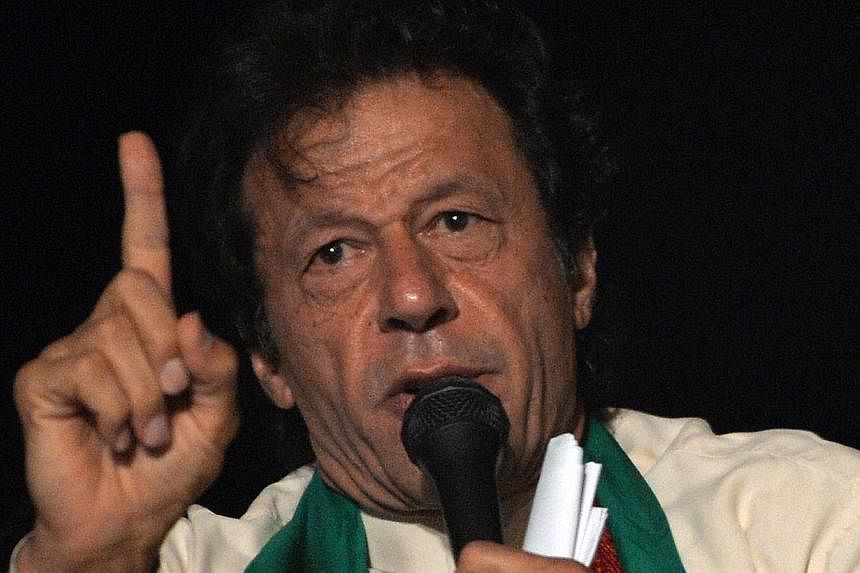 Pakistani cricketer-turned politician Imran Khan speaks to supporters on August 17, 2014 in Islamabad. He&nbsp;called on thousands of protesters to launch a civil disobedience movement against the government, as a leading cleric said that only a "rev