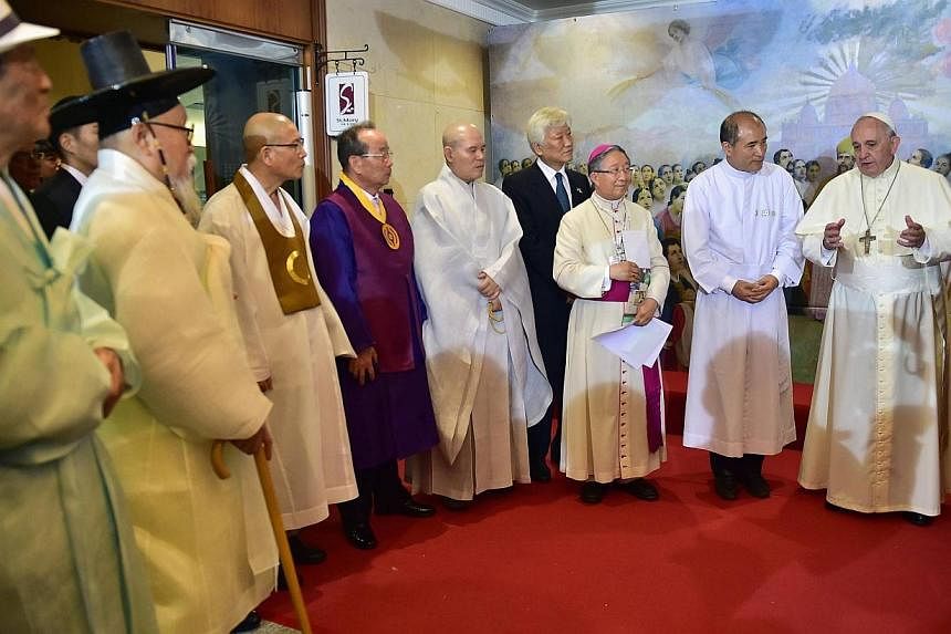 Pope Francis talks with South Korea's religious leaders at Myeong-dong Cathedral in Seoul on Aug 18, 2014.&nbsp;Pope Francis urged the divided Koreas to unite as "one family, one people" in a spirit of mutual forgiveness at a mass on Monday that coin