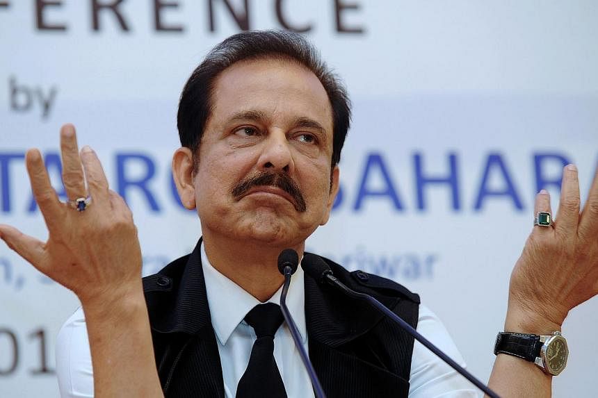 A file photo from November 2013 shows the chairman of India's Sahara Group, Subrata Roy, gesturing as he addresses a press conference in Kolkata. India's Supreme Court on August 14, 2014 gave Roy extra time to keep negotiating the sale of three luxur