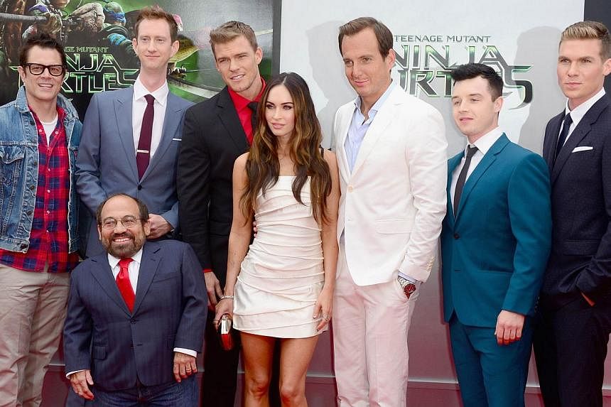 Actors (top, from left) Johnny Knoxville, Jeremy Howard, Alan Ritchson, Megan Fox, Will Arnett, Noel Fisher, Pete Ploszek and Danny Woodburn (front) attend Paramount Pictures' Teenage Mutant Ninja Turtles premiere in Westwood, California on August 3 