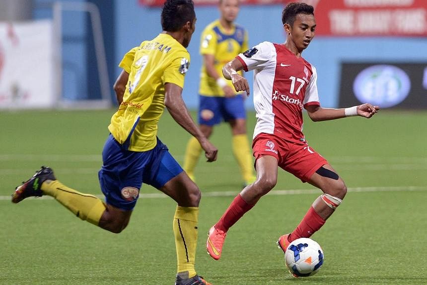 Faris Ramli (right) brings the ball forward while being watched by Saiful Nizam.&nbsp;The LionsXII's Malaysia Cup hopes now hang by a thread after losing 2-1 at home to holders Pahang. -- ST PHOTO: LIM SIN THAI
