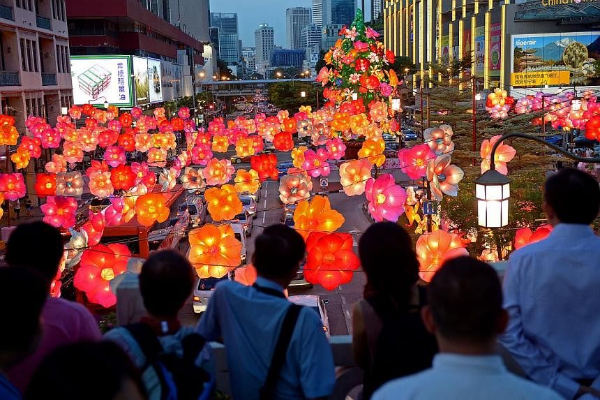 Chinatown is transformed into a kaleidscope landscape of floral lanterns during the Street Light-Up and release of Kong Ming lanterns at the Garden Bridge. -- ST PHOTO: DESMOND WEE
