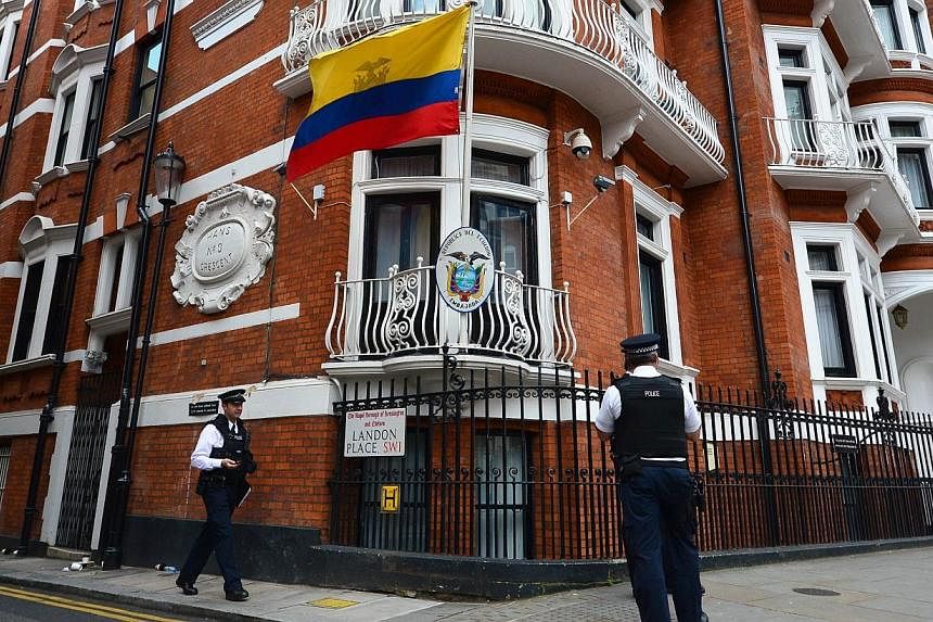 Police officers stand outside the Ecuadorian embassy in London, on Aug 18, 2014 where Wikileaks founder Julian Assange has been claiming asylum for over 2 years.&nbsp;Assange will not leave the Ecuador embassy in London until it is guaranteed he will